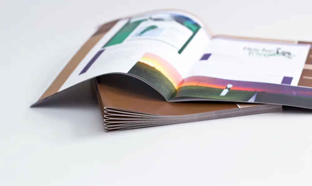 Graphic design booklet and brochure layouts stacked for printing